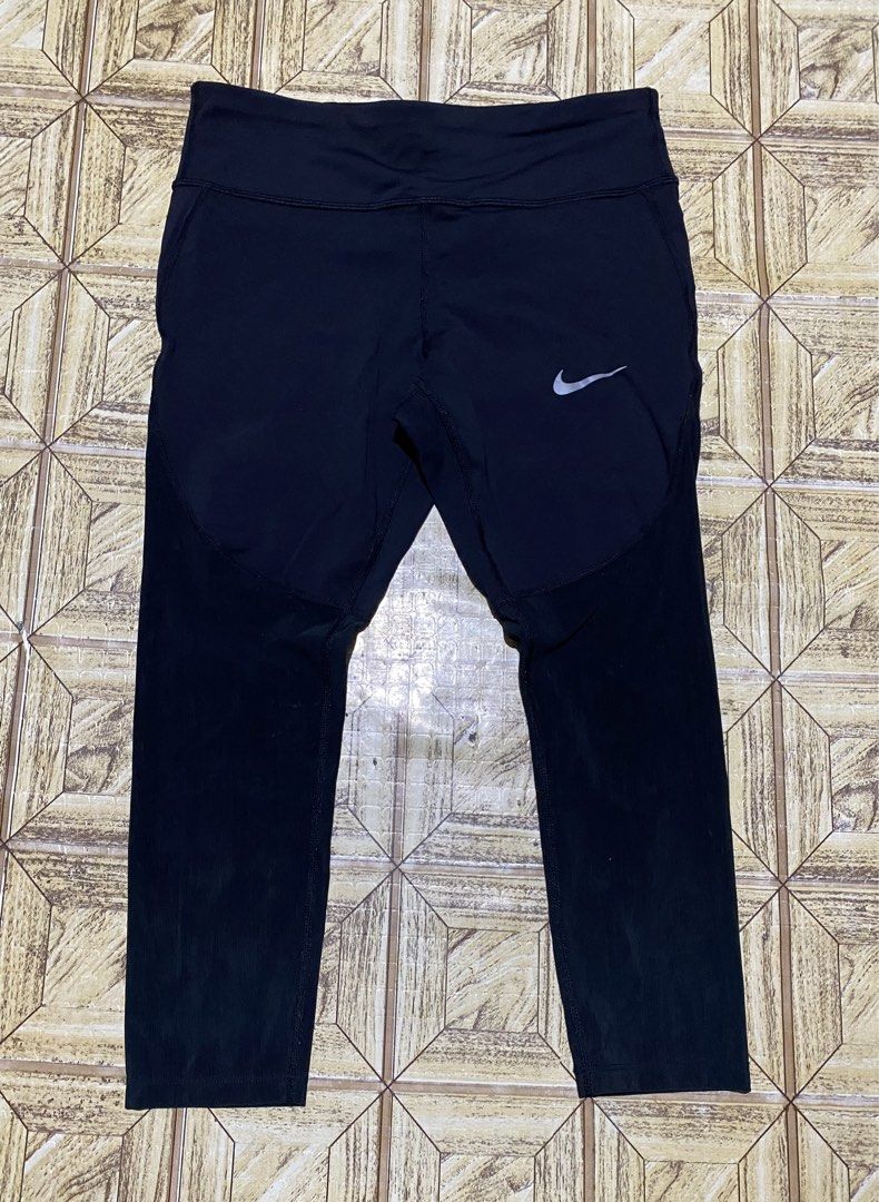 Nike Dri-FIT Running Leggings Size L (Category: Activewear) located in Manila. Submitted by tygaangub1096 (Listing ID 1469877600, Image 1). Description: Black Nike Dri-FIT running leggings in size large. Reflective swoosh logo on the front thigh. Inner drawstring waistband with repeating Nike Running print. Small zippered pocket on the back waistband. Moisture-wicking material. Great workout gear for training or daily runs. - Large on tag - Add s