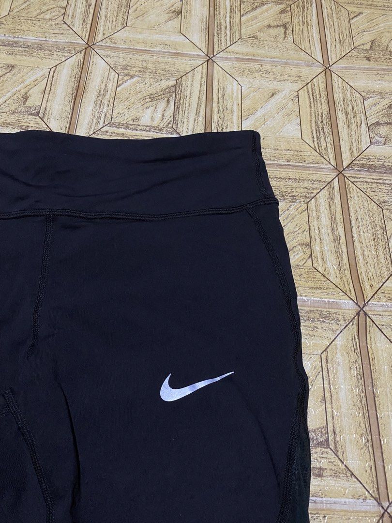 Nike Dri-FIT Running Leggings Size L (Category: Activewear) located in Manila. Submitted by tygaangub1096 (Listing ID 1469877600, Image 2). Description: Black Nike Dri-FIT running leggings in size large. Reflective swoosh logo on the front thigh. Inner drawstring waistband with repeating Nike Running print. Small zippered pocket on the back waistband. Moisture-wicking material. Great workout gear for training or daily runs. - Large on tag - Add s