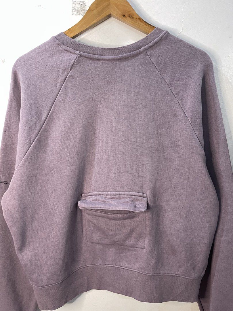 Nike Dusty Purple Cropped Sweatshirt (Category: Coats, Jackets and Outerwear) located in Cabagan. Submitted by blessingma81004 (Listing ID 1469766435, Image 3). Description: - Brand: Nike - Style: Crewneck sweatshirt with a trendy cropped fit and long sleeves - Size: XL - Color: Dusty purple - Details: Small silver embroidered Swoosh on chest, unique text graphics on the left sleeve, and a handy small pocket on the back near the hem - Origin: Mad