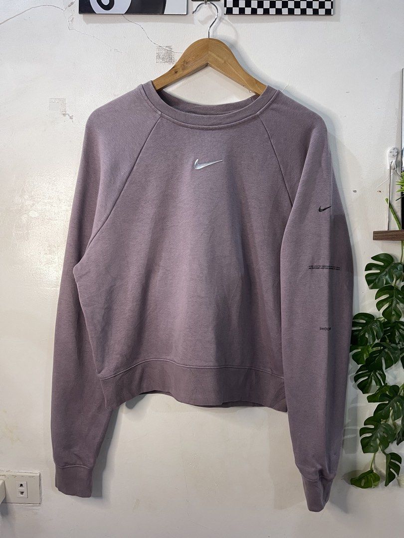 Nike Dusty Purple Cropped Sweatshirt (Category: Coats, Jackets and Outerwear) located in Cabagan. Submitted by blessingma81004 (Listing ID 1469766435, Image 2). Description: - Brand: Nike - Style: Crewneck sweatshirt with a trendy cropped fit and long sleeves - Size: XL - Color: Dusty purple - Details: Small silver embroidered Swoosh on chest, unique text graphics on the left sleeve, and a handy small pocket on the back near the hem - Origin: Mad