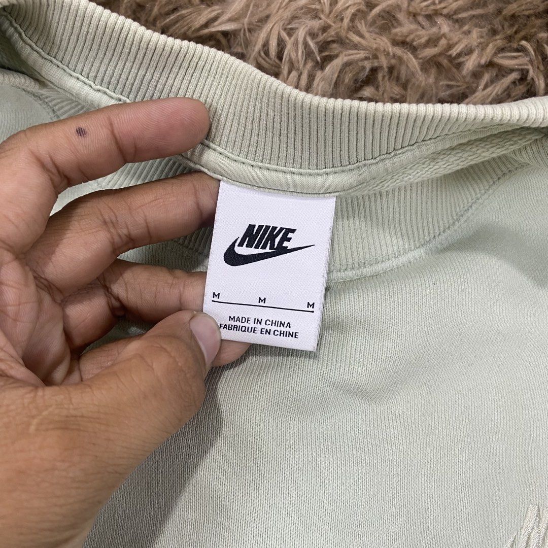 Nike Green Sweatshirt Size M (Category: Coats, Jackets and Outerwear) located in Cagayan de Oro. Submitted by sepamorash53558 (Listing ID 1469796868, Image 3). Description: - Brand: Nike - Style: Crewneck sweatshirt - Color: Light Green - Size: Medium (Tag attached) - Logo: Small embroidered Nike swoosh on left chest - Details: Ribbed collar, cuffs, and hem - Material: Body is 100% cotton; Ribbing is 96% cotton, 4% spandex - Origin: Made in China