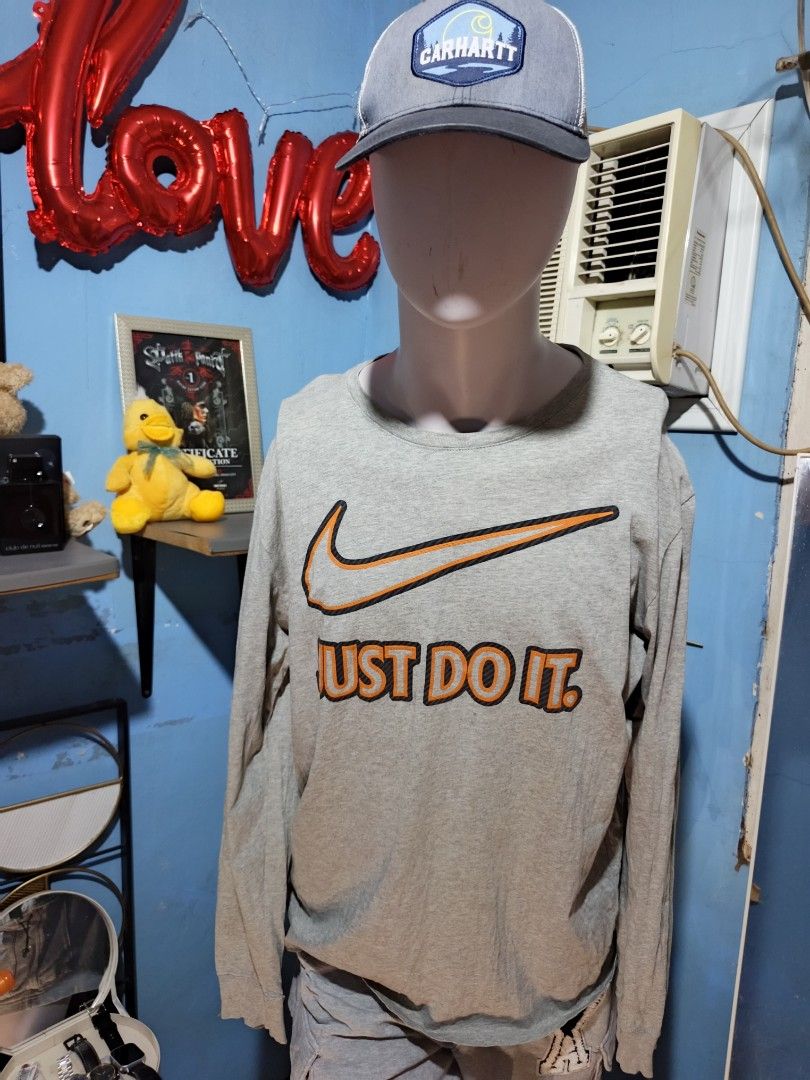 Nike Grey Long Sleeve Just Do It Sweatshirt (Category: Coats, Jackets and Outerwear) located in Davao. Submitted by romelyap (Listing ID 1469895041, Image 1). Description: - Brand: Nike23x27 - Style: Long sleeve crewneck sweater - Color: Grey with bold orange Swoosh and 'Just Do It' chest print - Material: Comfortable cotton blend - Details: Ribbed collar and cuffs for a snug fit - Condition: Clean fabric with bright, uncracked graphics - Sizing: