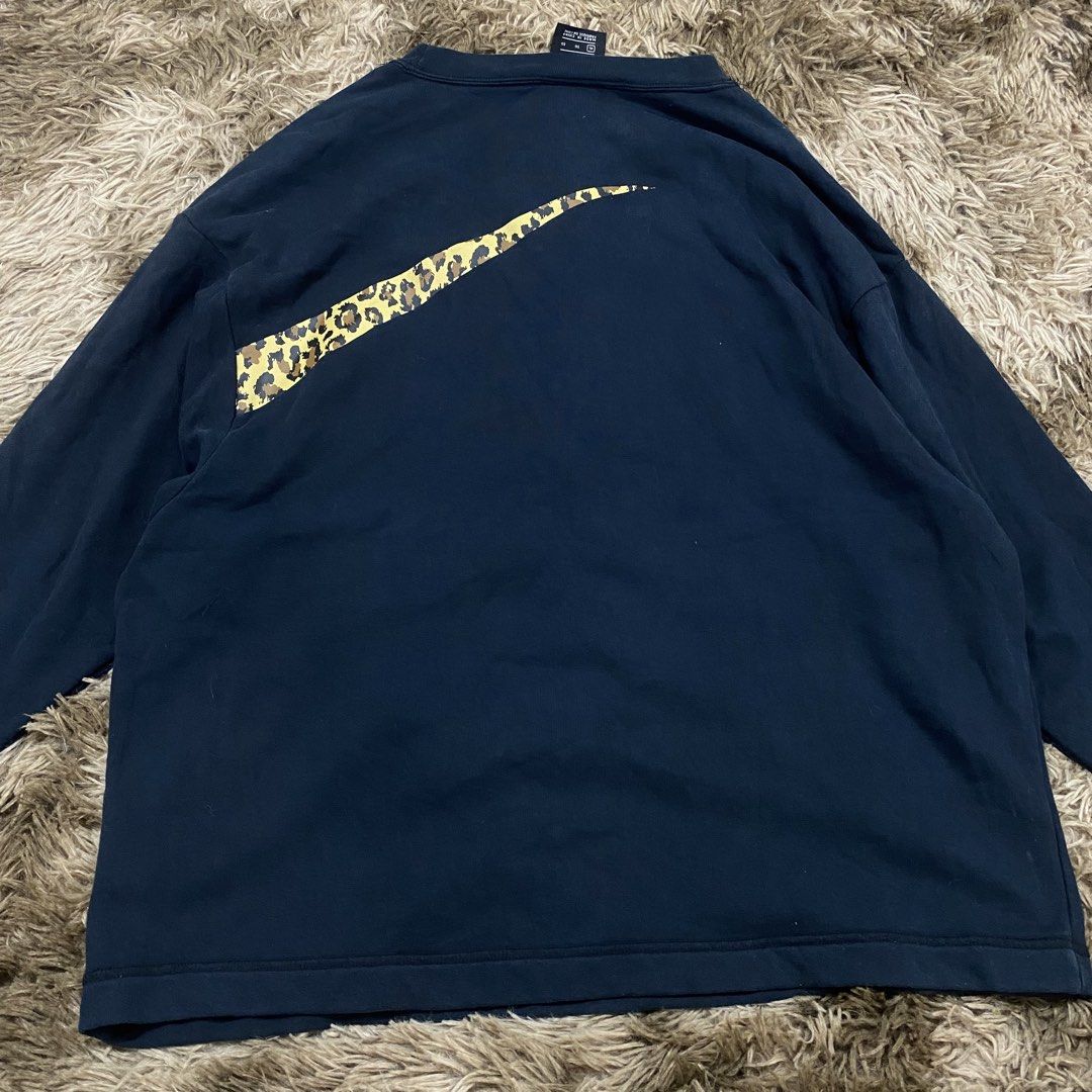 Nike Leopard Swoosh Black Sweatshirt Size XL (Category: Coats, Jackets and Outerwear) located in Cagayan de Oro. Submitted by sepamorash53558 (Listing ID 1469797440, Image 3). Description: - Brand: Nike - Color: Black - Size: XL - Material: 80% Cotton, 20% Polyester - Design: Large leopard print Swoosh graphic on the front with a matching small Swoosh wrap-around on the upper back - Style: Classic crewneck, long sleeves - Condition: Clean fabric 