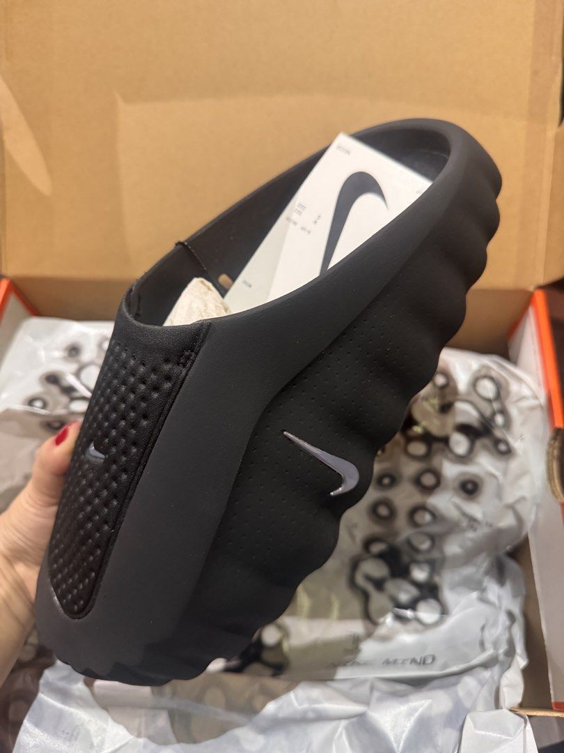 Nike mind 001 (Category: Slippers & Slides) located in Cavite. Submitted by elleeedc (Listing ID 1469829453, Image 3). Description: - Condition: Brand new / Deadstock straight from the retail box - Design: Convenient slip-on style with a breathable perforated toe box - Details: Sleek black upper with eye-catching bright orange pods on the sole - Inclusions: Comes with original box and hangtag attached Or SWAP SA SIZE 11.