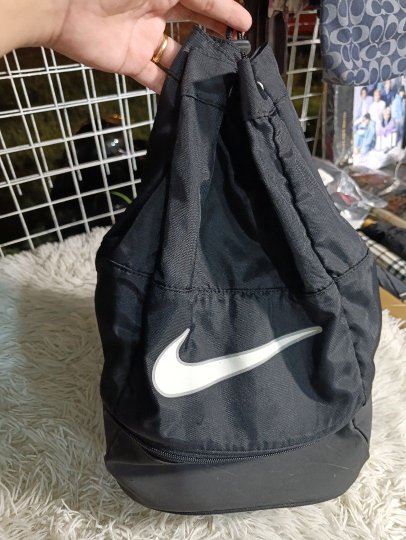 Nike Pool Bag (Category: Backpacks) located in Bacoor. Submitted by MommahAnnaOnlineShop (Listing ID 1469881648, Image 1). Description: - Brand: Nike - Color: Classic black with white swoosh logo - Material: Durable, high-quality nylon - Special Feature: Separate zipped bottom compartment ideal for shoes or wet gear - Closure: Drawstring cord with a secure toggle adjuster - Interior: Spacious main storage with official fabric care tag - Mode of P