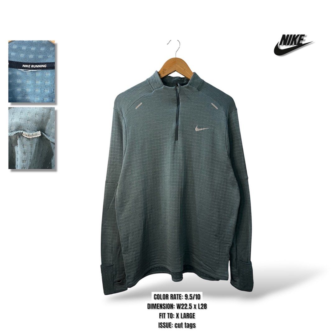 Nike Running Half-Zip Pullover (Category: Coats, Jackets and Outerwear) located in Cabagan. Submitted by blessingma81004 (Listing ID 1469769166, Image 1). Description: - Brand/Model: Nike Running Half-Zip Pullover - Color: Greyish-green - Size: XL (Chest: 22.5", Length: 28") - Material: Smooth exterior with textured waffle-knit interior - Features: Stand-up collar, zip closure, cuff thumbholes, and reflective chest details - Condition: 9.5/10 - N