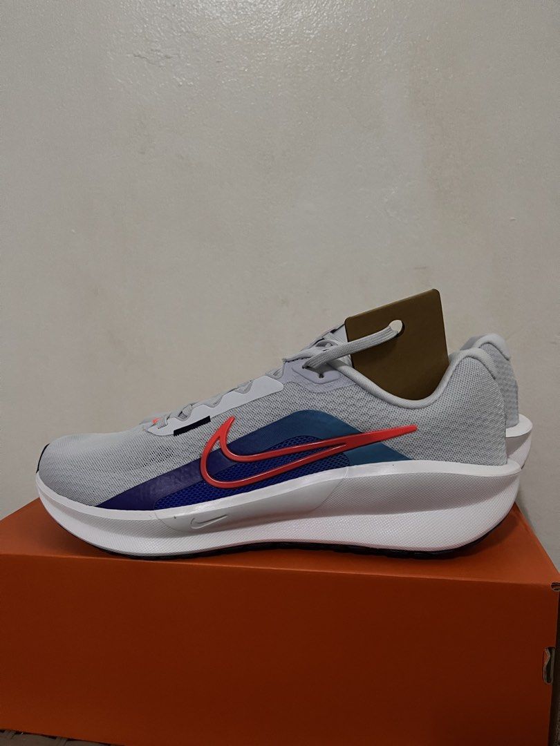 Nike Running Shoes Grey Red Blue (Category: Sneakers) located in Meycauayan. Submitted by ranastridran (Listing ID 1469805104, Image 1). Description: - Brand: Nike - Condition: Brand new / Unworn - Color: Grey with blue and red accents - Design: Double swoosh on the side - Material: Breathable mesh upper - Sole: Thick white midsole with black rubber outsole - Packaging: Comes with original orange shoebox.