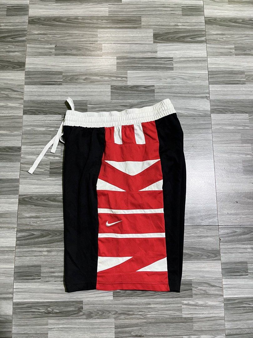 Nike Spell out (Category: Shorts) located in Cavite. Submitted by arespichri90266 (Listing ID 1469785051, Image 1). Description: - Brand: Nike - Style: Dri-FIT Basketball Shorts (Style Code: CV1866-010) - Size: Large - Colorway: Black, red, and white with a distinctive striped front panel - Features: Adjustable drawstring waist, white waistband, and embroidered white Nike swoosh - Material: 100% polyester - Origin: Made in Thailand - Condition: C