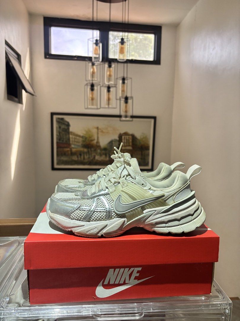 Nike V2K Run Metallic Silver White Sneakers (Category: Sneakers) located in Dinalupihan. Submitted by loved.by.jin (Listing ID 1469764580, Image 2). Description: - Model: Nike V2K Run - Colorway: Metallic Silver and White - Style: Chunky sole with breathable mesh upper - Closure: Standard lace-up fastening - Condition/Inclusions: Comes with original red Nike shoebox - Best for: Everyday wear, walking, and running errands.