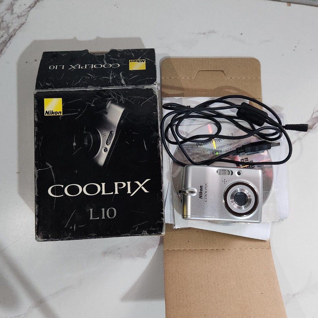 NIKON COOLPIX L10 DIGITAL CAMERA – COMPLETE SET (Category: Cameras) located in Bulacan. Submitted by h3nrpny (Listing ID 1469796161, Image 1). Description: NIKON COOLPIX L10 DIGITAL CAMERA – COMPLETE SET Vintage digicam released in 2007, featuring a 5MP CCD sensor and 3x optical zoom. Condition: Clean unit, fully working Inclusions: Original box Manuals Battery Memory card Location: Malabon / Bulacan.