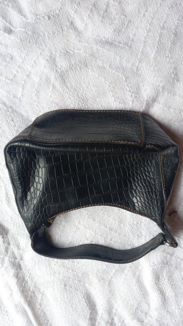 Nine West Black Crocodile Print Shoulder Bag (Category: Shoulder Bags) located in Rizal. Submitted by mayra74 (Listing ID 1469766416, Image 1). Description: - Brand: Nine West - Style: Black mini shoulder/kili bag with single strap - Material: Crocodile embossed faux leather with brown contrast stitching - Closure: Secure top zipper - Interior: Beige fabric lining with one zipper pocket - Condition: Clean overall, practical for daily use.