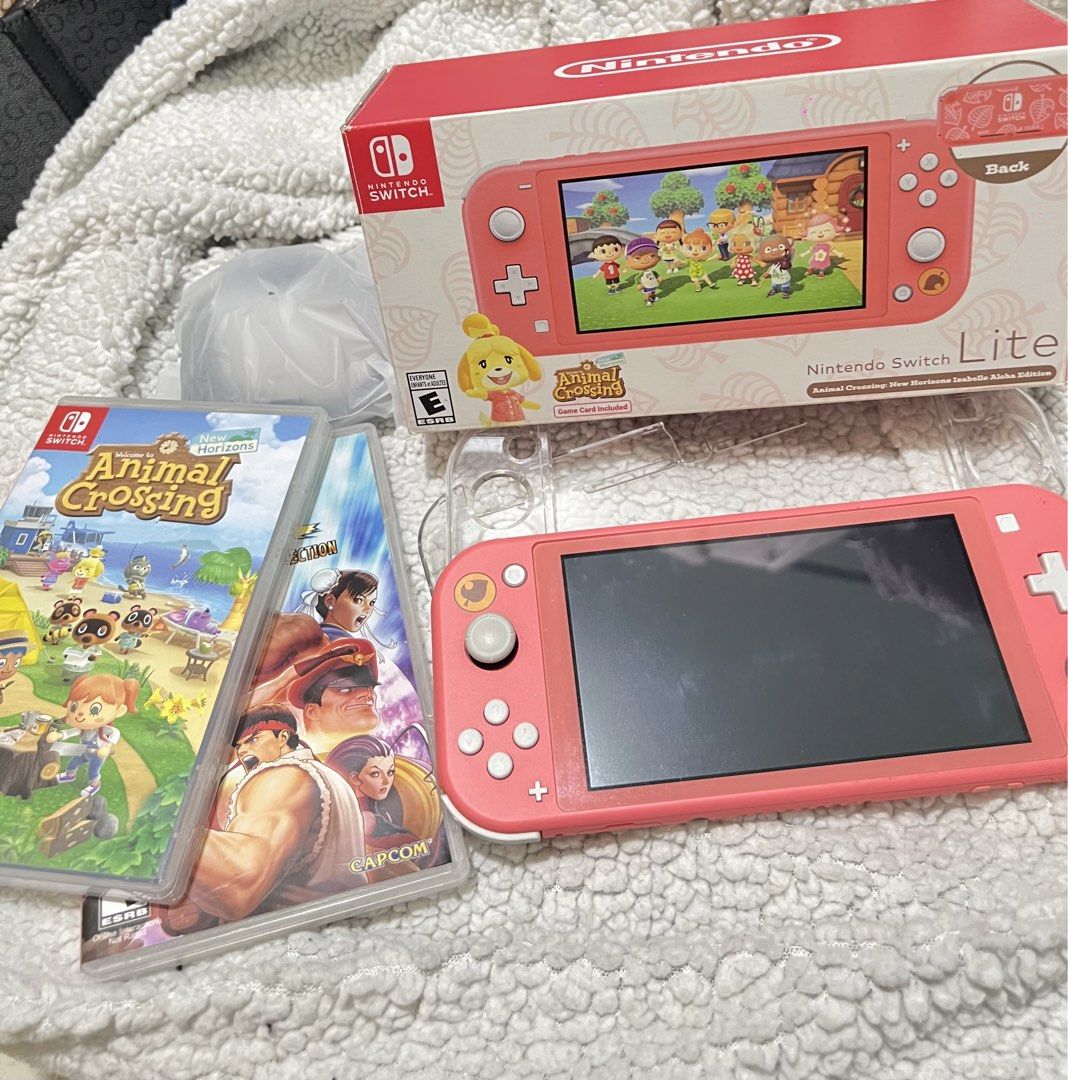 Nintendo Switch Lite Animal Crossing Edition (Bundle) (Category: Other Gadgets) located in Rizal. Submitted by shei04 (Listing ID 1469887756, Image 2). Description: - Nintendo Switch Lite Animal Crossing - Includes original box, charging cable, and clear protective case - Comes with Animal Crossing: New Horizons physical game card - Street fighter game - What you see in the photos is what you get (console bundle).
