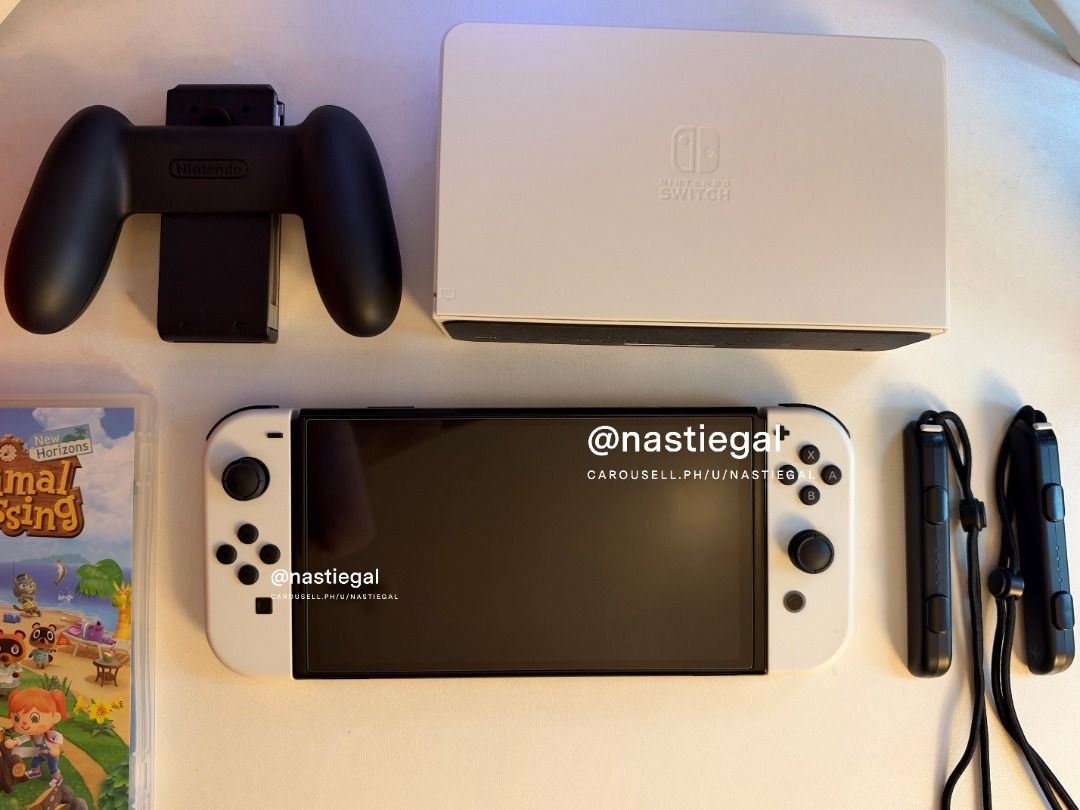 Nintendo Switch OLED White + Animal Crossing + Amiibos (Category: Nintendo) located in Las Pinas. Submitted by nastiegal (Listing ID 1469884351, Image 1). Description: - Nintendo Switch OLED Console (White) in pristine condition - Lady owned - With tempered glass since day 1 - Clean screen and hardware with zero issues - Complete with original dock, Joy-Con controllers, straps, grip, hdmi, charger and cord - Includes original box and Animal Cross