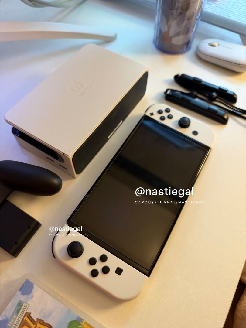 Nintendo Switch OLED White + Animal Crossing + Amiibos (Category: Nintendo) located in Las Pinas. Submitted by nastiegal (Listing ID 1469884351, Image 3). Description: - Nintendo Switch OLED Console (White) in pristine condition - Lady owned - With tempered glass since day 1 - Clean screen and hardware with zero issues - Complete with original dock, Joy-Con controllers, straps, grip, hdmi, charger and cord - Includes original box and Animal Cross