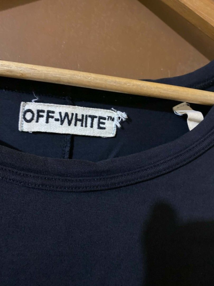 Off-White Black T-Shirt Size L (Category: Shirts) located in Taguig. Submitted by cabugchear34421 (Listing ID 1469879056, Image 3). Description: - Off-White c/o Virgil Abloh - Black - Large (Made in Portugal) - 100% cotton - Iconic diagonal stripes on the back with 'WHITE' text and small horizontal stripes near the front hem ISSUE: Crack prints Bacon neckline (slight).