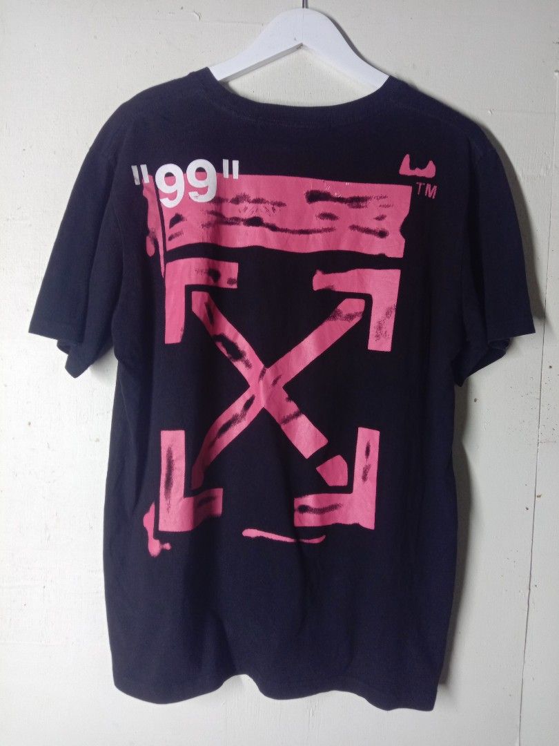 Off-White Impressionism 2019 Black T-Shirt (Category: Tshirts & Polo Shirts ) located in Talavera. Submitted by cookiess. (Listing ID 1469893679, Image 2). Description: - Brand: Off-White - Collection: 2019 Impressionism - Color: Black - Material: 100% Cotton - Design: Front circle logo with "IMPRESSIONISM" text; large pink spray-paint arrows graphic with "99" on the back - Fit: Crew neck, short sleeves, straight hemline - Condition/Details: Main