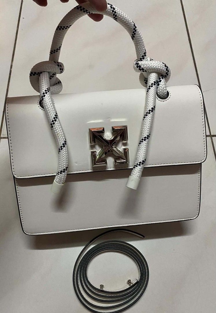Off-White White Leather Burrow Bag with Rope Handle (Category: Shoulder Bags) located in Manila. Submitted by gutierrez23265 (Listing ID 1469784481, Image 1). Description: Off-White leather handbag in clean white. Distinctive rope top handle with knotted details. Silver tone arrow closure on the front flap. Structured rectangular silhouette with clean black edge painting. Interior slip pocket with subtle debossed logo branding. Removable thin lea