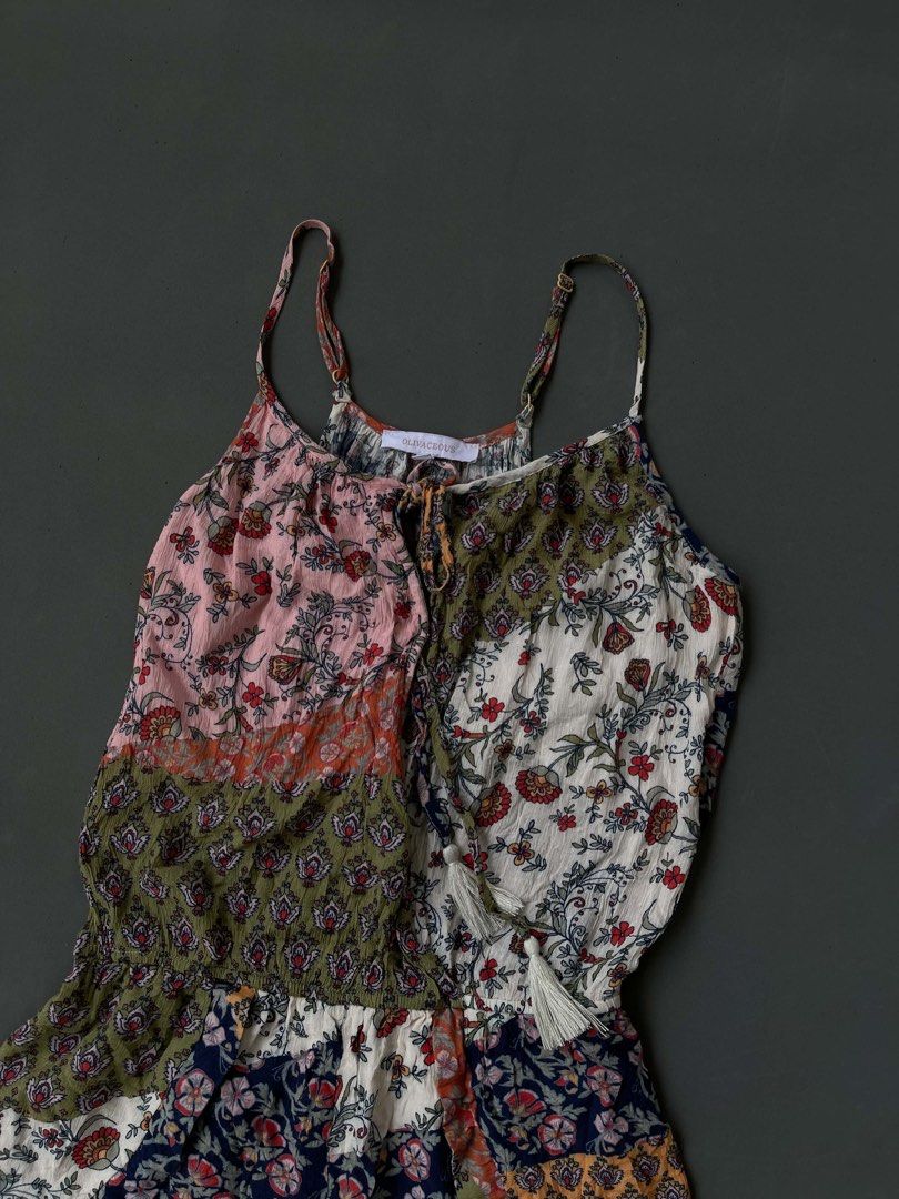 Olivaceous Floral Patchwork Spaghetti Strap Romper Size S (Category: Rompers) located in Baguio. Submitted by lovelaira (Listing ID 1469852811, Image 2). Description: Olivaceous brand, size S. Colorful floral patchwork design with mixed patterns in pink, green, white, and navy blue. Spaghetti straps with adjustable gold-tone sliders. Scoop neckline featuring tassel drawstring ties. Lightweight fabric, cinched elastic waist, flowy shorts construct