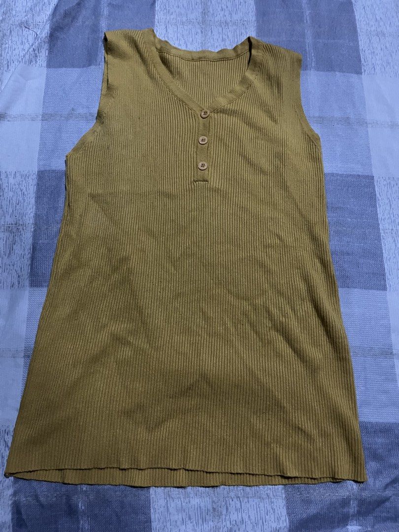 Olive green ribbed sleeveless top with buttons (Category: Sleeveless) located in Legazpi City. Submitted by chynnunez (Listing ID 1469875485, Image 1). Description: Olive green sleeveless top with a ribbed texture. V-neckline featuring three matching buttons down the front. Stretchy fabric, relaxed fit. .