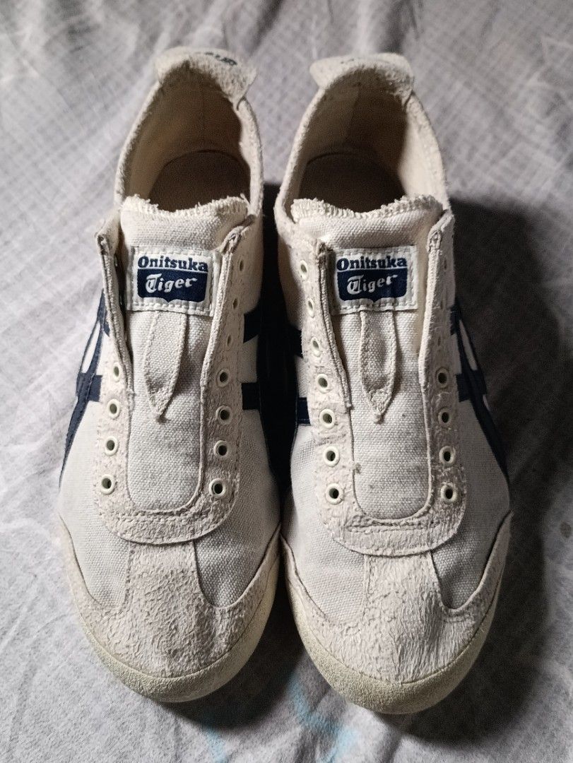 Onitsuka Tiger Mexico 66 Canvas Off-White Navy (Category: Sneakers) located in Manila. Submitted by keenforest.c4b4c0 (Listing ID 1469865414, Image 2). Description: - Brand: Onitsuka Tiger Mexico 66 - Colorway: Off-white canvas with iconic navy blue stripes - Style: Low-profile heritage runner with branded heel tabs - Condition: Uppers show light wear with textured suede toe bumpers; soles are clean with minimal tread wear - Flaw: Laces are missi