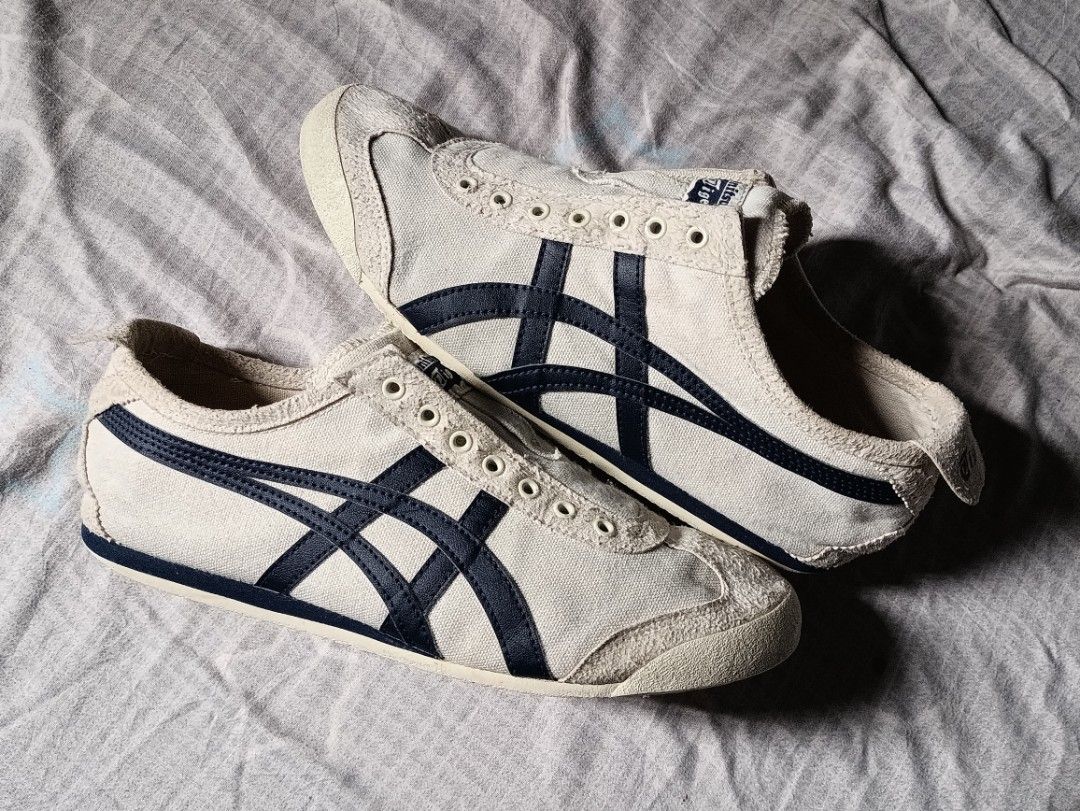 Onitsuka Tiger Mexico 66 Canvas Off-White Navy (Category: Sneakers) located in Manila. Submitted by keenforest.c4b4c0 (Listing ID 1469865414, Image 1). Description: - Brand: Onitsuka Tiger Mexico 66 - Colorway: Off-white canvas with iconic navy blue stripes - Style: Low-profile heritage runner with branded heel tabs - Condition: Uppers show light wear with textured suede toe bumpers; soles are clean with minimal tread wear - Flaw: Laces are missi