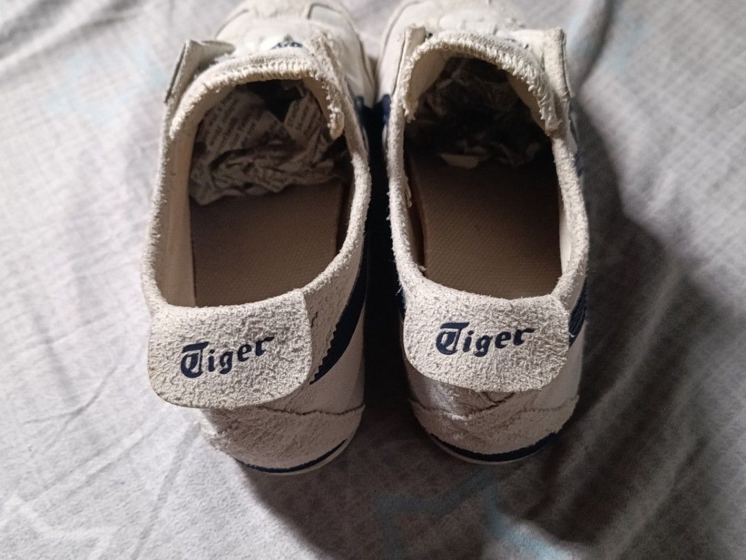 Onitsuka Tiger Mexico 66 Canvas Off-White Navy (Category: Sneakers) located in Manila. Submitted by keenforest.c4b4c0 (Listing ID 1469865414, Image 3). Description: - Brand: Onitsuka Tiger Mexico 66 - Colorway: Off-white canvas with iconic navy blue stripes - Style: Low-profile heritage runner with branded heel tabs - Condition: Uppers show light wear with textured suede toe bumpers; soles are clean with minimal tread wear - Flaw: Laces are missi