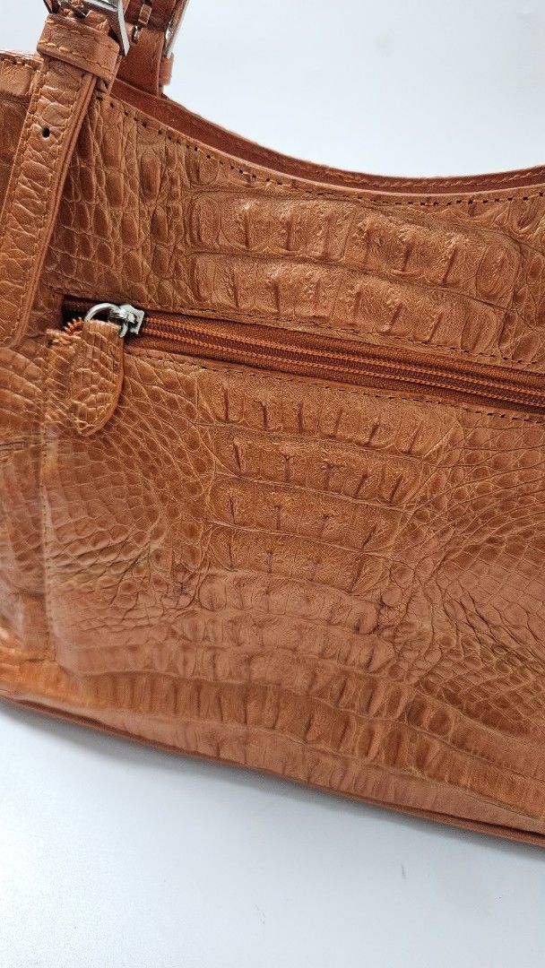 Orange Croc Leather Shoulder Tote Bag (Category: Tote Bags) located in Alfonso. Submitted by jbcamet (Listing ID 1469860867, Image 3). Description: - Color & Texture: Vibrant bright orange with a stylish faux crocodile finish - Straps: Double shoulder straps equipped with adjustable buckles - Closures: Secure zip closures on both the outer pocket and main compartment - Interior: Dark brown fabric lining featuring multiple slip and zip pockets for