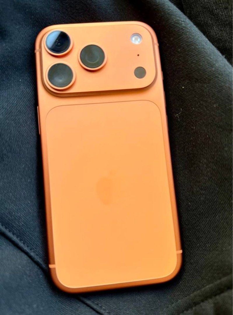 Orange iPhone 17 Pro Max (Category: Cases & Sleeves) located in Mandaluyong City. Submitted by tkbuys (Listing ID 1469796015, Image 2). Description: FOR SALE: iPhone 17 Pro Max – Orange - 512GB | Open Line - Pristine | No issues | 100% Battery - Complete set + Box | Under Warranty RFS: Upgrading to MacBook.