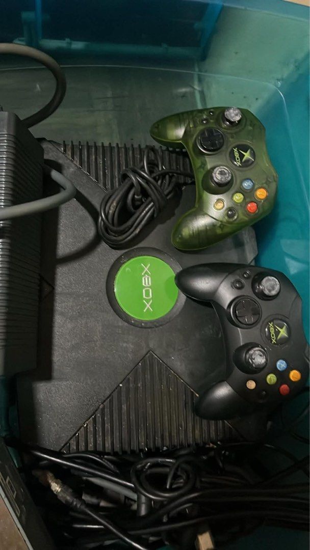 Original Xbox Console with Two Controllers and Cables (Category: Xbox) located in Manila. Submitted by quickocean_30656b (Listing ID 1469845945, Image 1). Description: - Original Microsoft Xbox console - Includes 2 controllers: 1 standard black and 1 translucent green - Complete with power brick and connection cables - Tested and working great - Ideal for retro gaming fans and collectors - Meet-ups and shipping available across the Philippines.