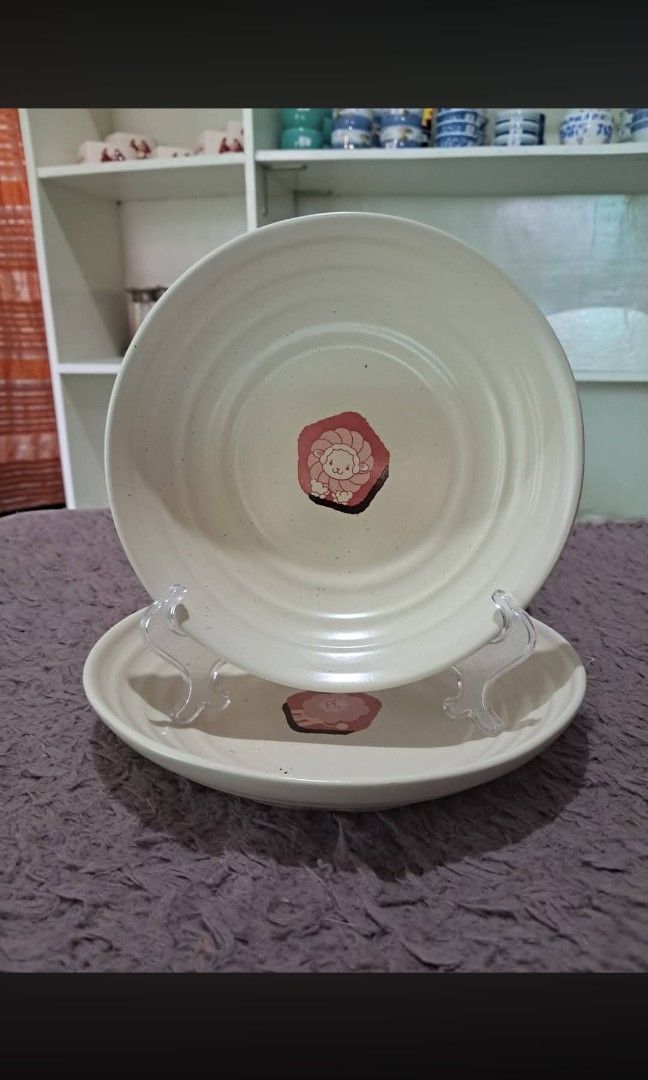 Pasta plate (Category: Dinnerware & Cutlery) located in Cavite. Submitted by secretjapansurplus (Listing ID 1469909142, Image 1). Description: This is a 2-piece ceramic pasta and curry plate set from the official 2005 Mister Donut limited-edition promotional collection from Japan. The set features two different sizes of deep, ivory-colored ceramic dishes designed with elegant concentric ridges: • Large Plate (Pon De Lion): Measures approximately 