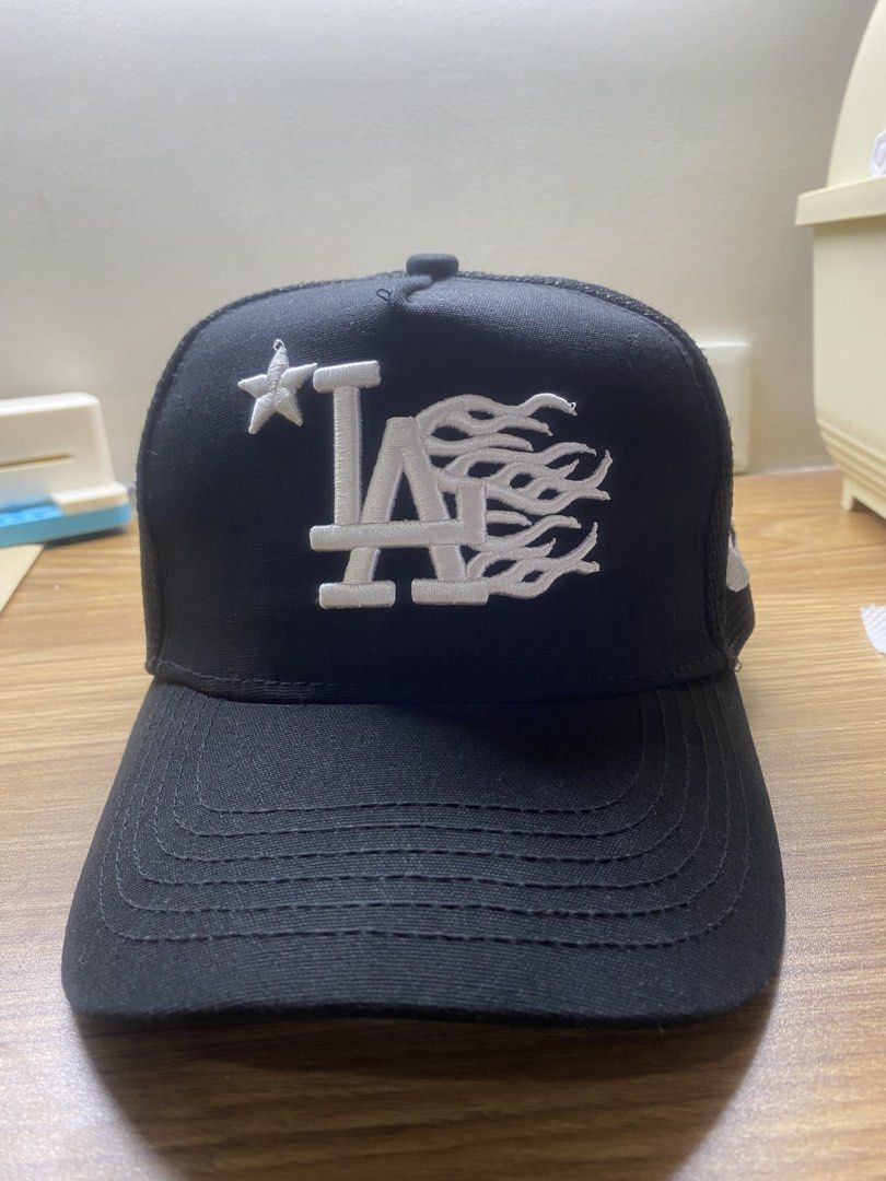 Path To Paradise Black LA Flames Trucker Hat (Category: Caps & Hats) located in Manila. Submitted by brent.0765 (Listing ID 1469817102, Image 1). Description: - Brand: Path To Paradise - Color: Black with white embroidery - Design: LA logo with flame graphics on front and side panels - Material: Structured front with breathable mesh backing - Fit: Adjustable snapback closure - Details: Branded taping inside the crown - Condition: Brand new / Exce
