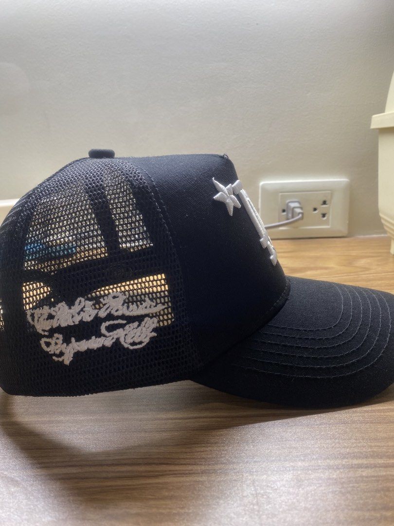 Path To Paradise Black LA Flames Trucker Hat (Category: Caps & Hats) located in Manila. Submitted by brent.0765 (Listing ID 1469817102, Image 3). Description: - Brand: Path To Paradise - Color: Black with white embroidery - Design: LA logo with flame graphics on front and side panels - Material: Structured front with breathable mesh backing - Fit: Adjustable snapback closure - Details: Branded taping inside the crown - Condition: Brand new / Exce