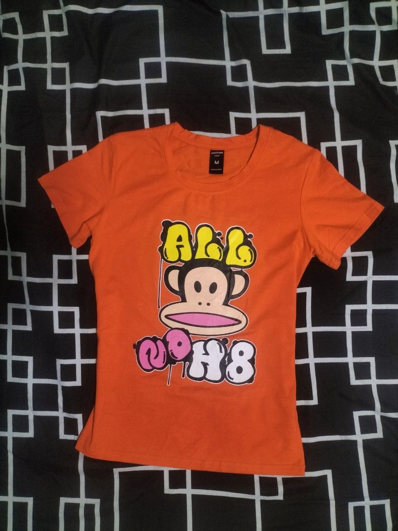Paul Frank Orange T-shirt (Category: Shirts) located in Manila. Submitted by fareastthrift (Listing ID 1469847407, Image 1). Description: - Brand: Paul Frank - Color: Bright Orange - Size: Medium (tag attached) - Design: Julius the monkey graphic with text art - Material: Soft cotton blend - Fit: Short sleeves, crew neck - Condition: Great casual top for everyday wear.
