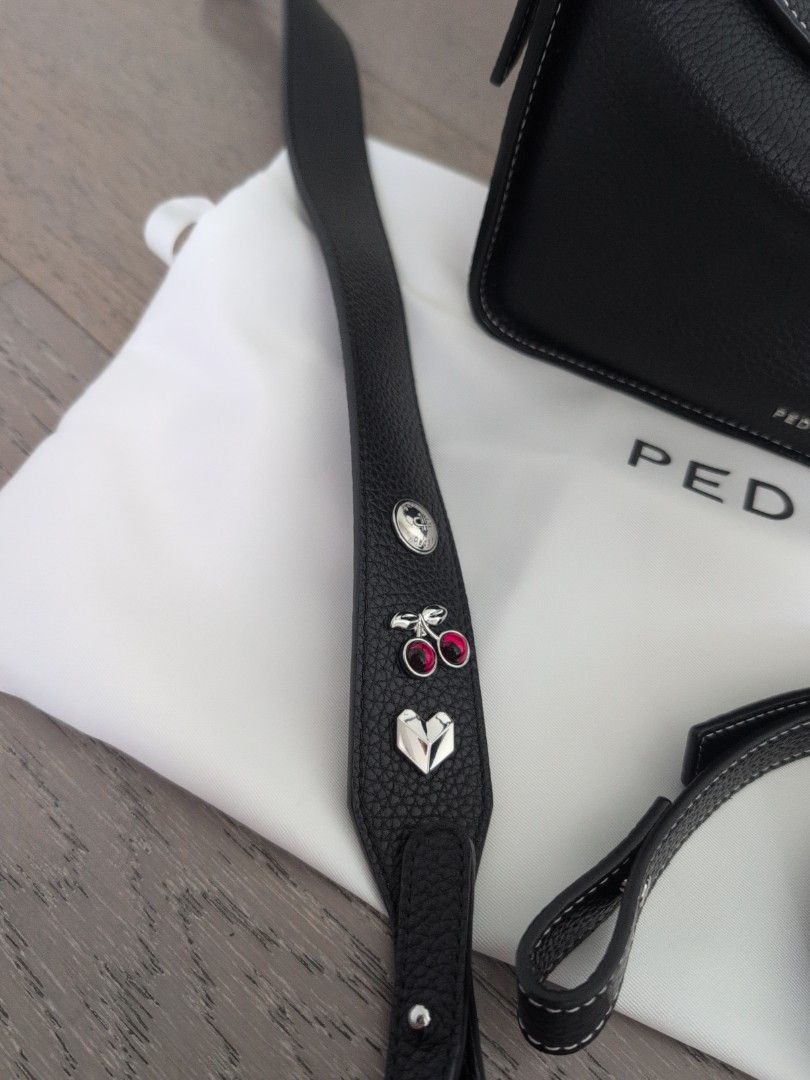 Pedro Demi w/ extra charm strap (Category: Luxury Bags & Wallets) located in Makati City. Submitted by g.jo.h (Listing ID 1469761480, Image 3). Description: - Brand: Pedro - Material: Premium grainy leather in classic black - Design: Elegant white contrast stitching with a clean, structured shape - Hardware: Durable and solid - Inclusions: Original dust bag and versatile extra strap - Special Feature: Extra strap is decorated with cute metal char