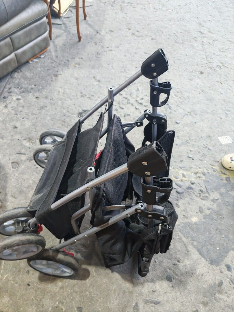 Pet stroller japan surplus (Category: Homes & Other Pet Accessories) located in Manila. Submitted by aks_japansurplus30 (Listing ID 1469809751, Image 1). Description: Black pet stroller for small dogs or cats. Mesh windows provide ventilation and visibility. Includes a top canopy, rear zipper entry, parent tray with cup holders, and a bottom storage basket. Folds down flat for easy transport and storage. Sturdy metal frame with smooth-rolling whe