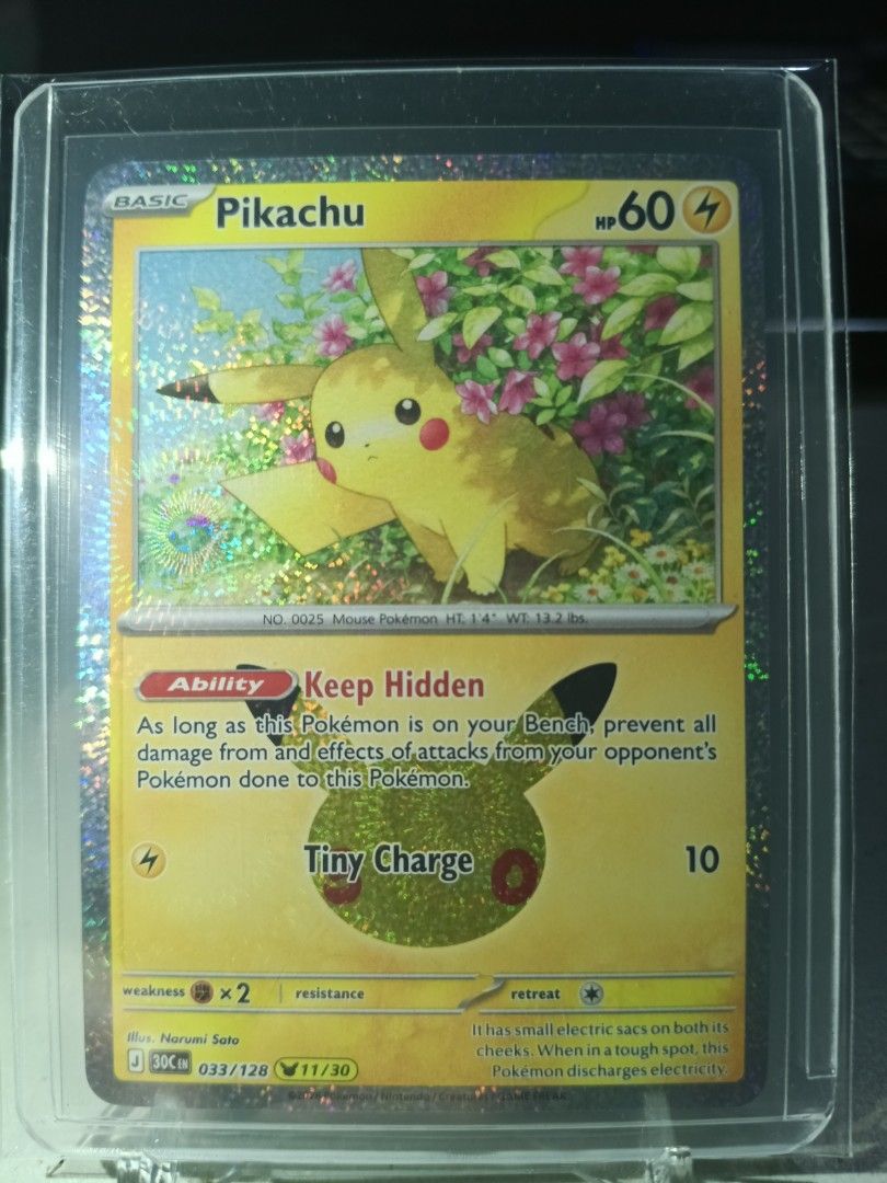 Pikachu 033/128 (Category: Raw Singles) located in General Trias. Submitted by hobbyshare19 (Listing ID 1469828075, Image 1). Description: WTS (Want to Sell) • Character Name: Pikachu (Narumi Sato Art - with Pikachu 30th Celebration stamp) • Card Code: 033/128 (11/30) • Rarity: Pikachu Rare / Holo • Set: 30th Celebration Expansion Set • Condition: Near Mint (Kept in OPP plastic + toploader + toploader sleeve) • Price: ₱100 • Location: General Tri