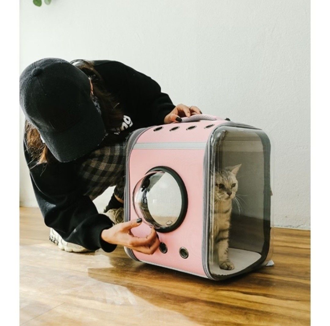 Pink Bubble Window Cat Backpack Carrier (Category: Homes & Other Pet Accessories) located in Cainta. Submitted by ej_emuslan (Listing ID 1469790002, Image 2). Description: - Color/Design: Pink with grey trim and a trendy clear front bubble window - Perfect For: Small cats and dogs - Ventilation: Multiple holes to keep your pet cool and comfortable - Closure: Secure edge-to-edge zippers - Portability: Sturdy top handle for easy carrying.
