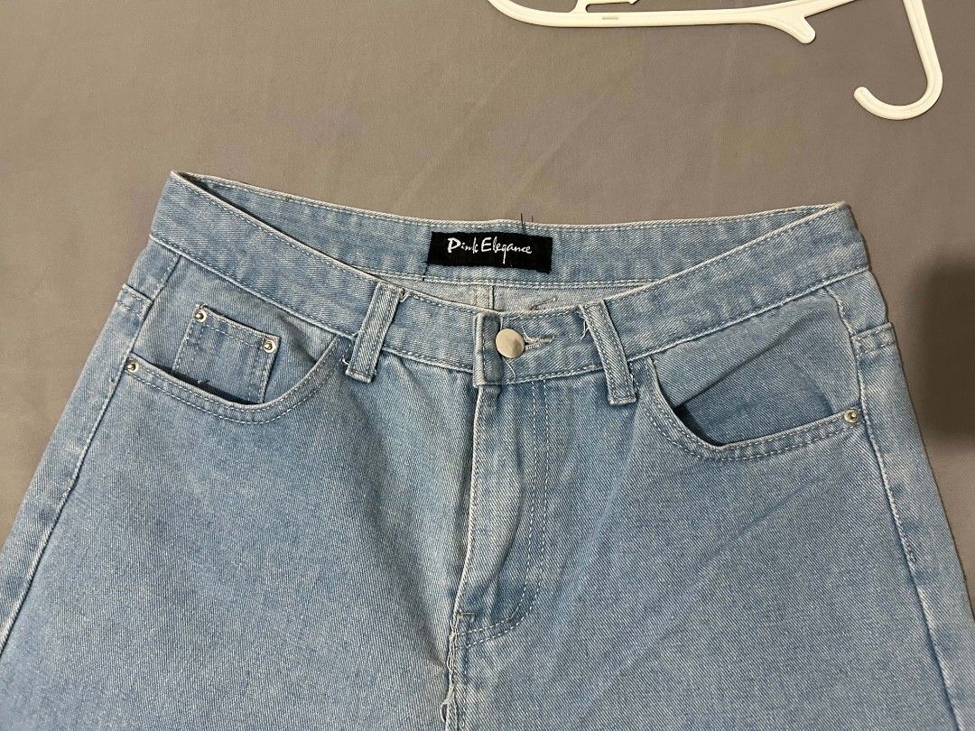 Pink Elegance Light Blue Denim Jeans (Category: Jeans) located in Bacoor. Submitted by _ayeiiii (Listing ID 1469830658, Image 3). Description: - Brand: Pink Elegance - Wash: Light denim - Cut: Straight leg, mid-rise - Closure: Metal button - Pockets: Front pockets with small coin pocket detail - Condition: Great everyday staple piece, pairs easily with tees and crop tops - waistline: 28-29 - fabric: stretchy - pm for more photos discounts for mul