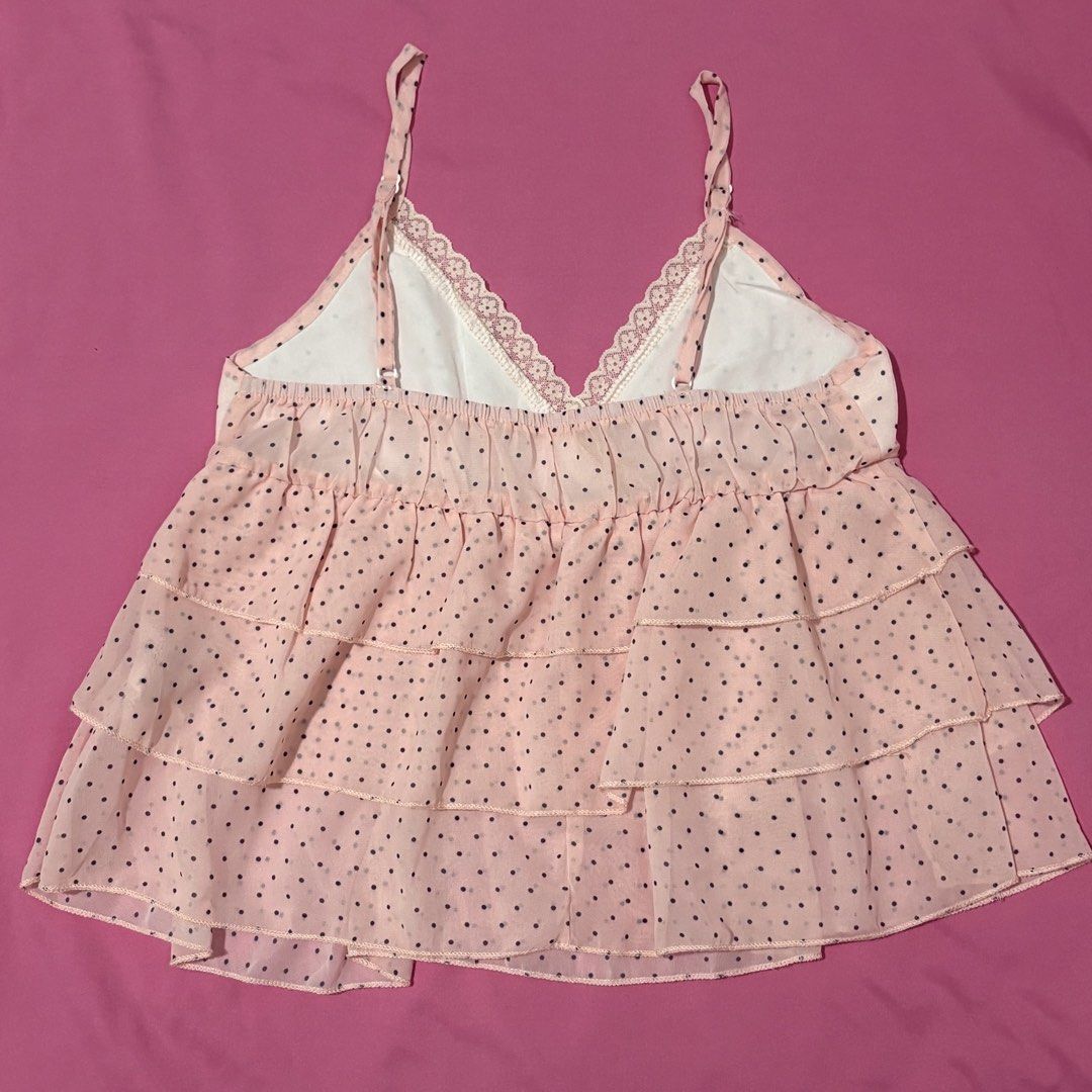 Pink polka dot cami top with ruffled layers (Category: Sleeveless) located in Quezon City. Submitted by luna_ily (Listing ID 1469927831, Image 2). Description: 🍒 Send a message for more pictures (such as when worn) and inquiries. Location: Cubao, Quezon City Mode of delivery: J&T and Lalamove (shipping fee will be shouldered by the buyer) Mode of payment: GCash, Maya, GoTyme .