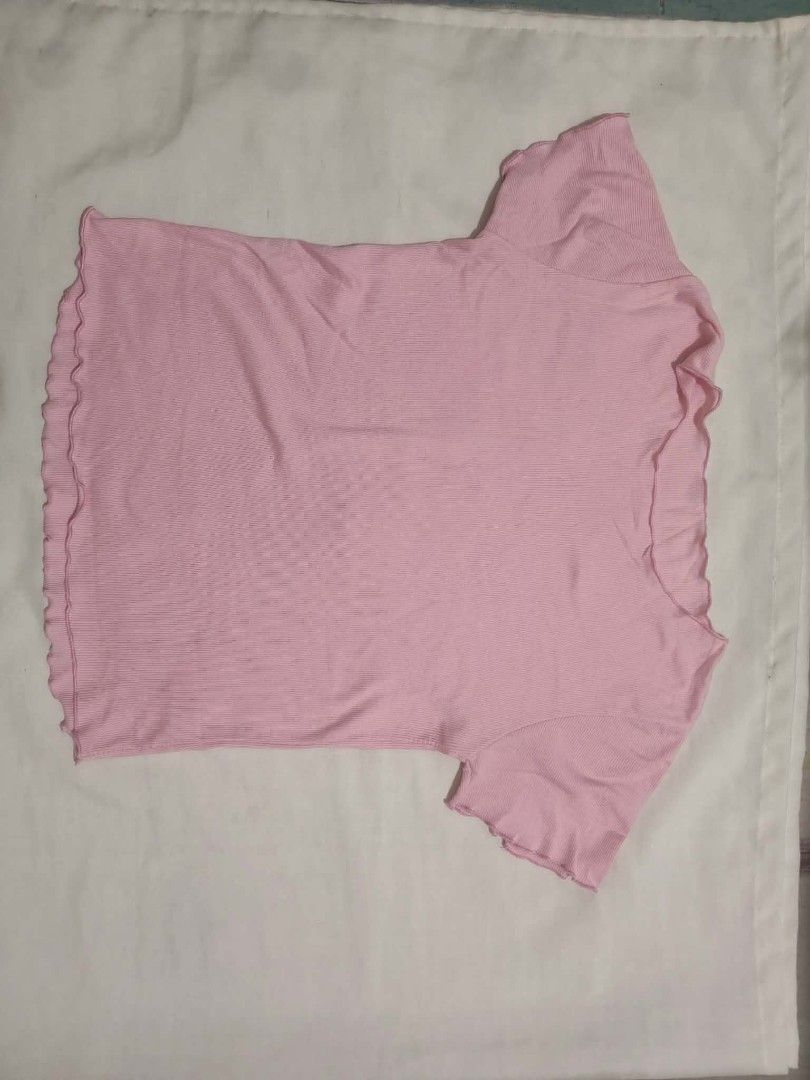 Pink ribbed lettuce hem short sleeve top (Category: Shirts) located in Santa Rosa. Submitted by barbshie (Listing ID 1469826969, Image 1). Description: - Color: Light pink - Fabric: Soft, stretchy ribbed material - Design: Scoop neckline with adorable lettuce hem on sleeves, neckline, and bottom - Fit: Comfortable for daily wear, easily pairs with high-waisted jeans or skirts - Condition: Clean, no stains or damage.