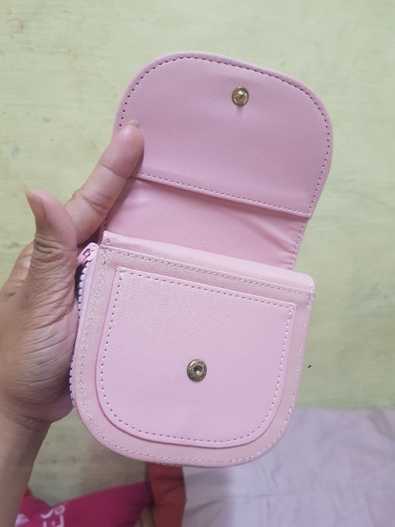 Pink round leather short wallet with snap button and zip (Category: Wallets & Card holders) located in Quezon City. Submitted by wends1598 (Listing ID 1469765423, Image 2). Description: - Color: Cute pink - Design: Trifold with a rounded flap closure and mini circular logo badge - Closures: Secure snap button and side zippered coin compartment - Interior: Multiple card slots and cash compartments - Size: Compact and pocket-friendly, perfect for s