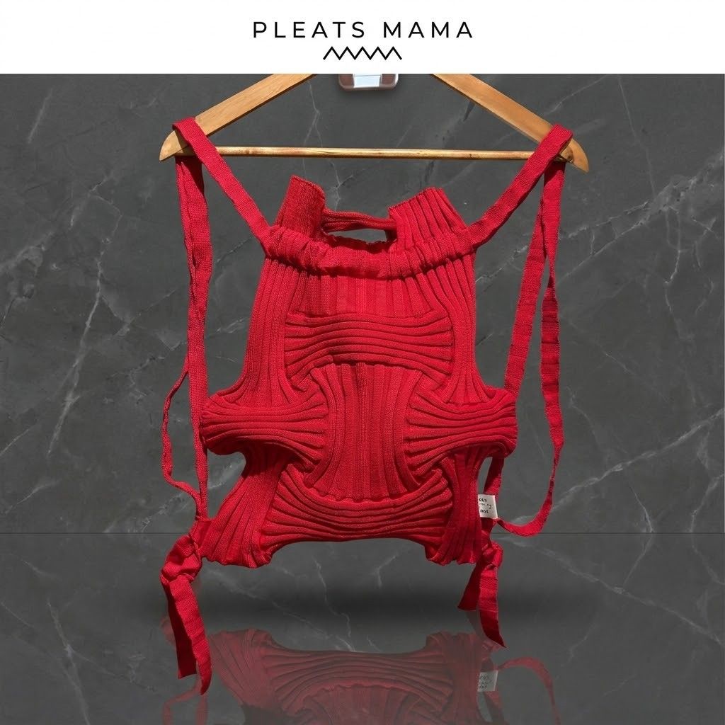 Pleats Mama Red Knitted Backpack (Category: Backpacks) located in Carmen. Submitted by ar_thrift00 (Listing ID 1469892903, Image 1). Description: - Brand: Pleats Mama - Style: Pleated knit backpack in a vibrant bright red - Design: Unique structural ribbed texture throughout with interior brand label - Closure: Drawstring opening at the top with matching shoulder straps - Features: Lightweight, easy to fold, and packable for travel - Condition: E