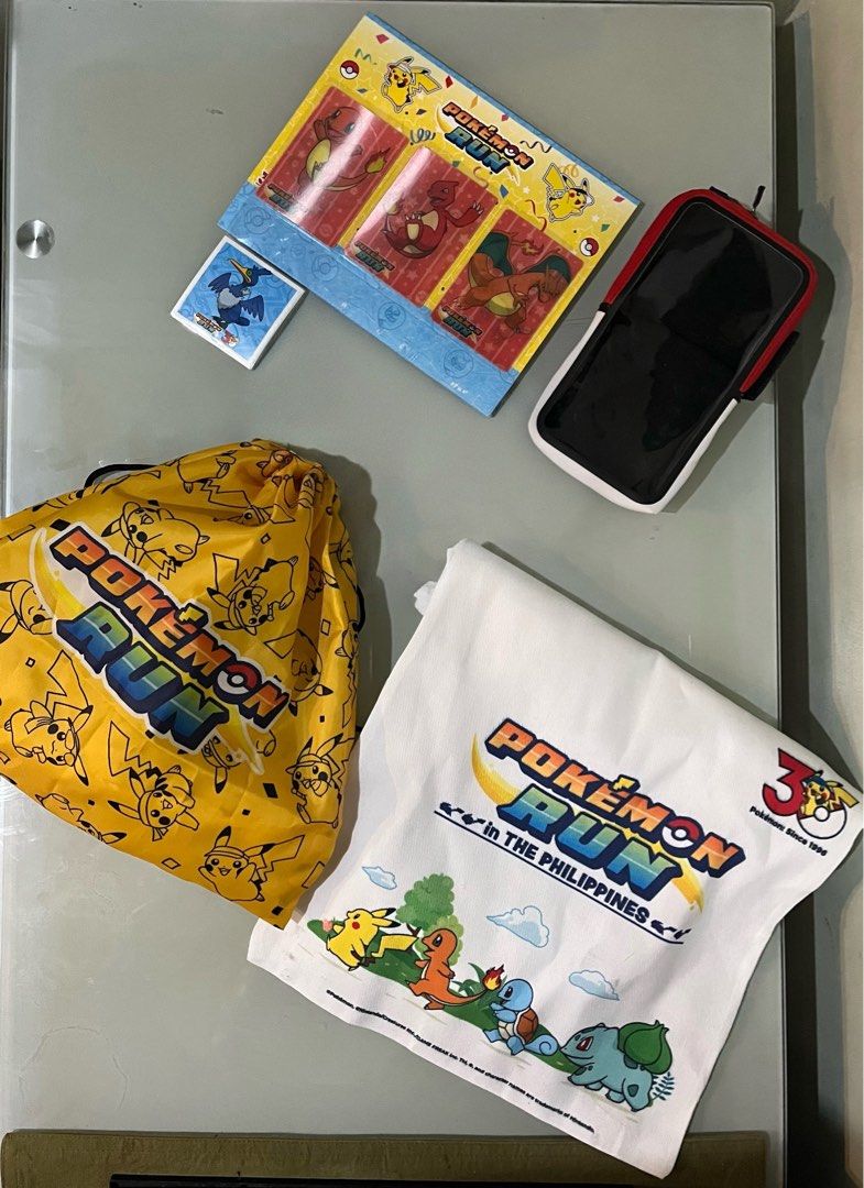 Pokémon Run 30th Anniv Merchandise (Category: Character Goods) located in Pasig City. Submitted by jc_mag (Listing ID 1469832623, Image 1). Description: - Official Pokémon Run Philippines event merchandise loot set - Charmander evolution lenticular card folder - Sticker pack - Pokemon Themed arm phone band .