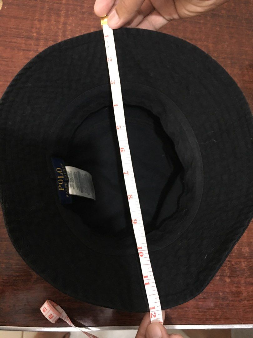 Polo Ralph Lauren Black Bucket Hat (Category: Caps & Hats) located in Mandaluyong City. Submitted by cjdp17 (Listing ID 1468317757, Image 3). Description: - Brand: Polo Ralph Lauren - Color: Black with embroidered white pony logo - Material: 100% cotton - Size: One size (59cm) - Condition: Good, with interior tag intact; needs a quick lint roll or clean due to surface dust - Perfect casual accessory for sunny days.