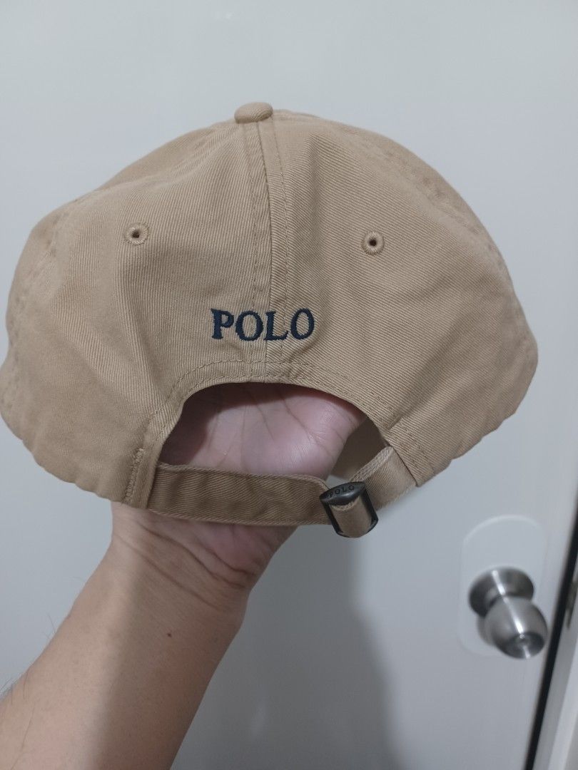 Polo Ralph Lauren Khaki Baseball Cap (Category: Caps & Hats) located in Mandaluyong City. Submitted by usamenfashionhaul (Listing ID 1469917794, Image 1). Description: - Brand: Polo Ralph Lauren - Color: Khaki beige with navy blue embroidered pony logo - Material: Comfortable cotton - Features: Breathable eyelets and embroidered POLO lettering on the back - Closure: Adjustable strap with metal buckle - Condition: Clean with minimal wear.