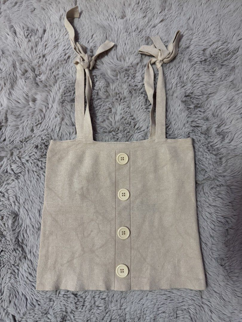 Pomelo Beige Knit Tank Top Size M (Category: Sleeveless) located in Calamba. Submitted by cheriiv (Listing ID 1469886393, Image 1). Description: - Brand: Pomelo - Style: Ribbed knit tank top - Color: Beige - Size: Medium (M) - Details: Adjustable tie-shoulder straps and front decorative buttons - Material: Soft and stretchy knit fabric.