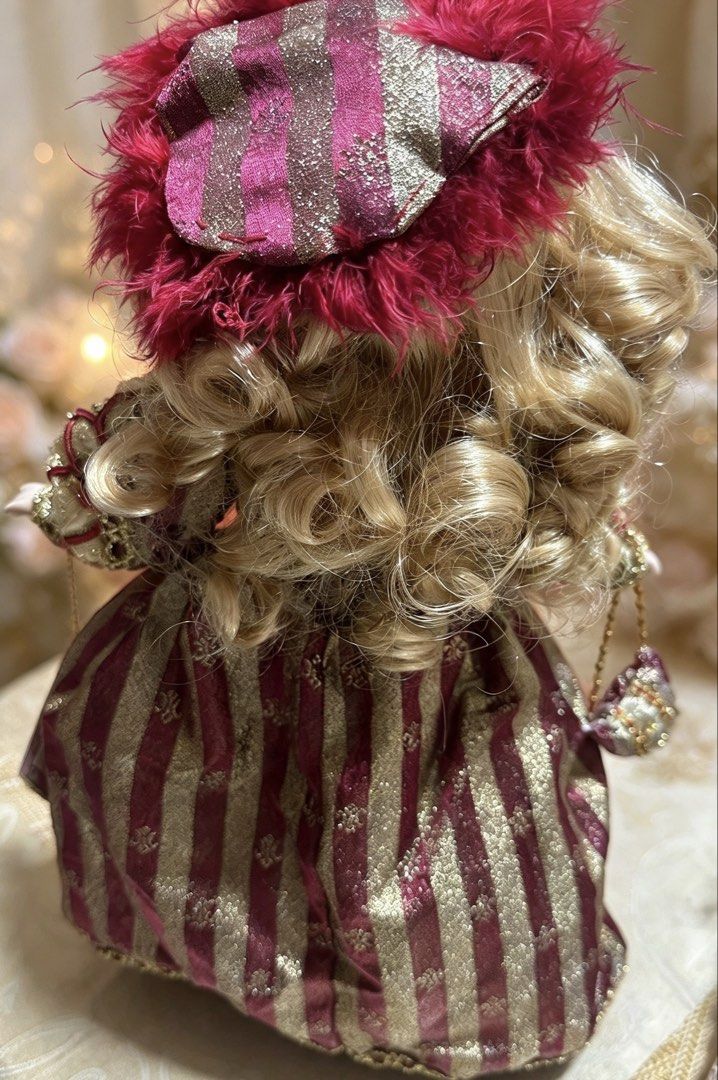 Porcelain Dolls (Category: Vintage Collectibles) located in San Pablo. Submitted by goldenfinds.co (Listing ID 1469773791, Image 3). Description: Porcelain doll collection. Each doll comes with a display stand. No boxes. 👑 Doll 1: Renaissance Doll (Melissa Collection) • Burgundy and gold striped brocade gown with red cord and bead detailing • Magenta feather hat, hanging purse, beaded necklace and drop earrings • Curly blonde hair, green eyes • 