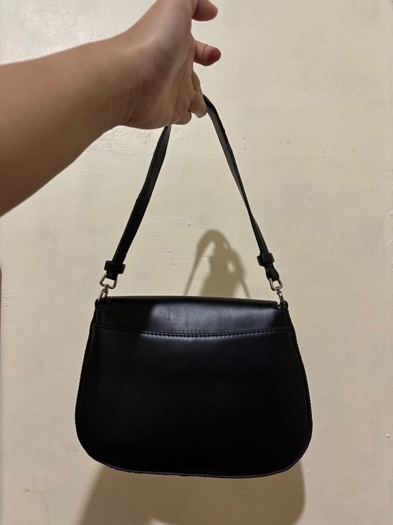 Prada Black Leather Shoulder Bag (Category: Luxury Bags & Wallets) located in Caloocan City. Submitted by freeriver-79bd71 (Listing ID 1469892619, Image 2). Description: - Authentic Prada black leather shoulder bag - Classic flap closure with sleek silver hardware - Iconic triangular Prada logo on the front - Smooth leather finish with a clean structure - Comfortable adjustable strap - Prada logo tag inside the clean interior - Timeless design th
