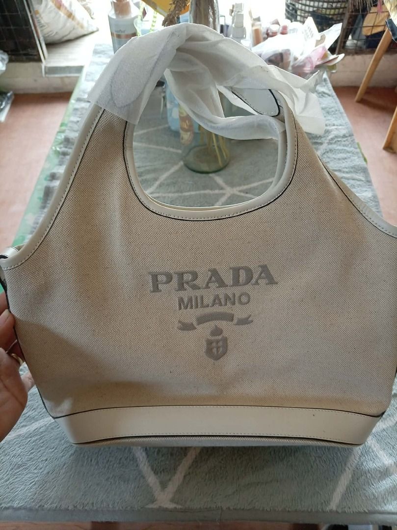 Prada canvas handbag (Category: Purses & Pouches) located in Aborlan. Submitted by adelasays (Listing ID 1469936507, Image 1). Description: Free shipping! Ukay source No flaws, looks brand new coz there's platic on handle when we got it from the box. With free unbranded bag for sure buyer. .