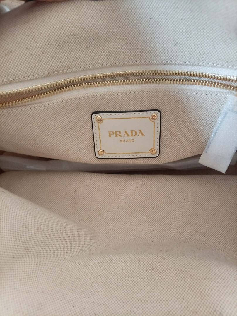 Prada canvas handbag (Category: Purses & Pouches) located in Aborlan. Submitted by adelasays (Listing ID 1469936507, Image 3). Description: Free shipping! Ukay source No flaws, looks brand new coz there's platic on handle when we got it from the box. With free unbranded bag for sure buyer. .